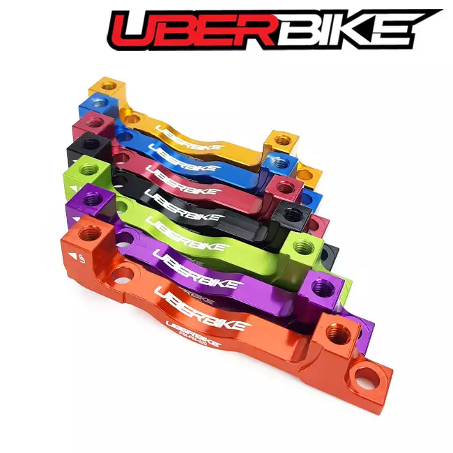 Selection of Uberbike Post to Post 180mm-220mm Disc Brake adapter - in different colours.