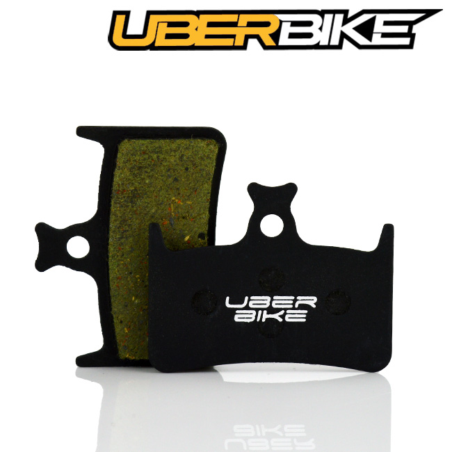 Black Semi Metallic Uberbike disc brake pad for Hope E4 with Uberbike logo across the middle of it.