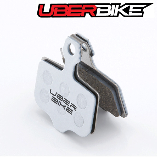 White Uberbike Race Matrix disc brake pad with Uberbike logo in middle of it.