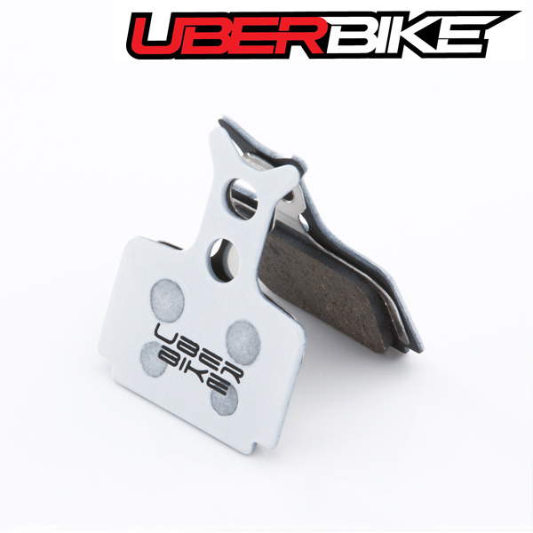 White Uberbike Race Matrix Disc brake pad with Uberbike logo on it.