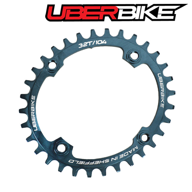 Grey colour oval 104/32T chainring, with white writing along the edges of it saying Uberbike and Made in Sheffield