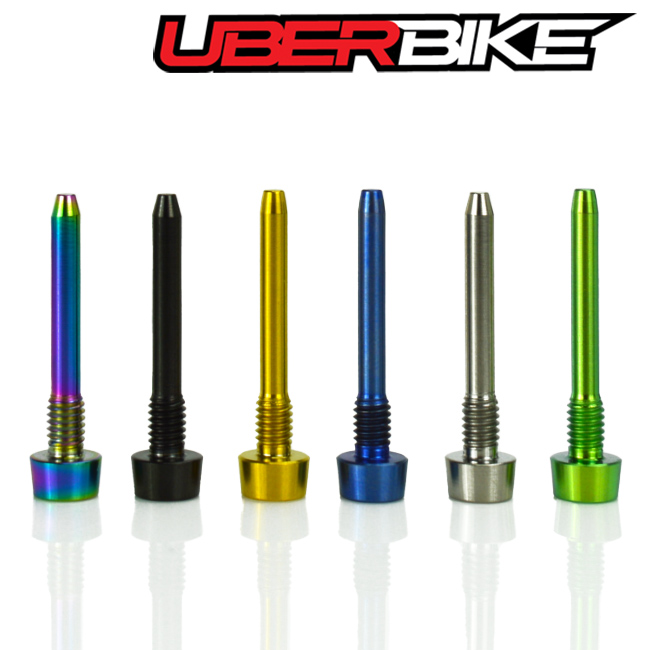 assortment of caliper retaining pins, all on their heads in a row on a white background