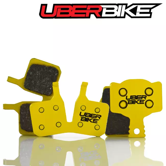 2 sets of yellow disc brake pads for Magura MT Trail the Uberbike logo is in the middle