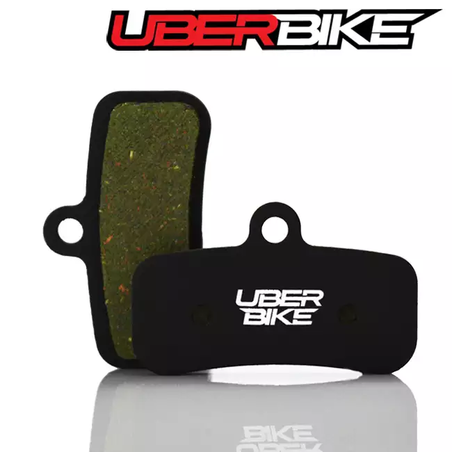 Black Semi Metallic Uberbike disc brake pads for Shimano Saint with the Uberbike logo across the middle of them.