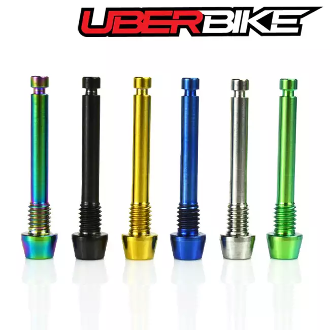 6 Uberbike Shimano Titanium Pad Retaining pins in a row - oil slikc, black, gold, bllue, raw and green colours.