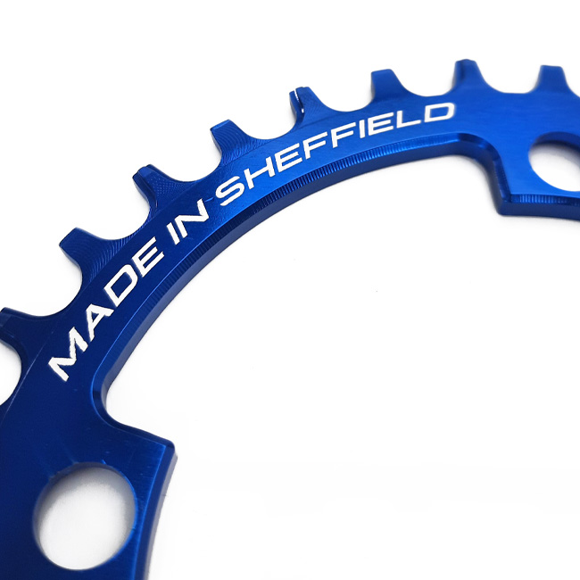 Close up of Uberbike blue Made in Sheffield chainring.