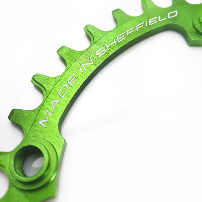 Close up of Uberbike Made in Sheffield green oval chainring.