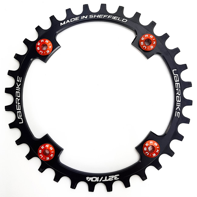 Made In Sheffield Uberbike Chainring with 4 orange Uberbike chainring bolts fitted in it.