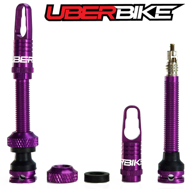 Each part of purple Uberbike Airtech CNC Tubeless Valve dusplayed separately.